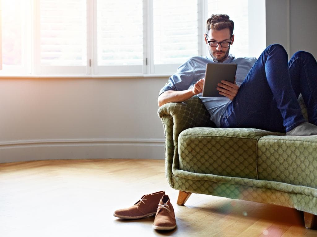 Person on couch with tablet L