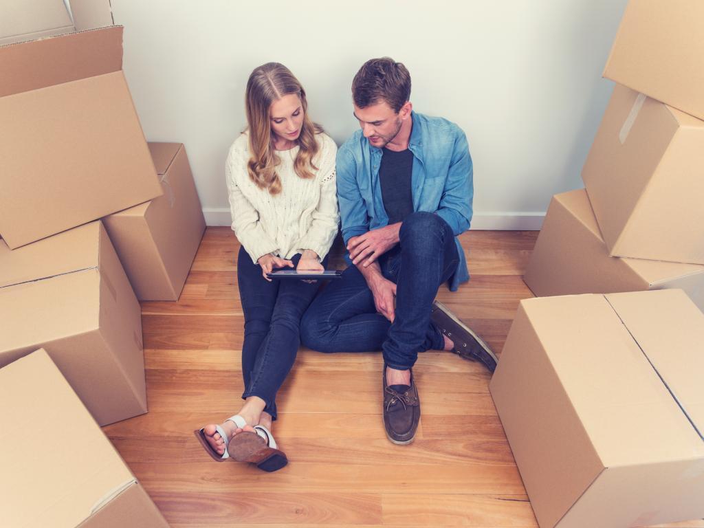 Couple surrounded by moving boxes L